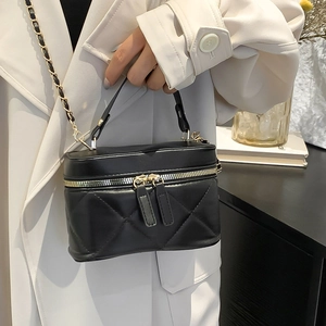 Quilted black leather mini box bag with gold chain strap and elegant handle