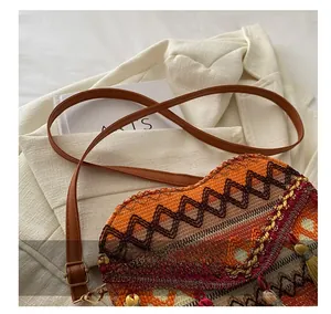 Close-up of ethnic woven bag featuring colorful geometric patterns and decorative tassels