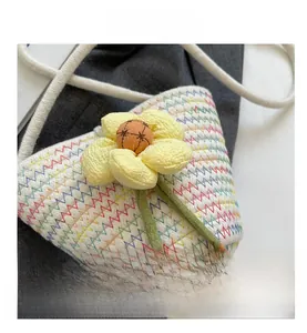 Detailed macro view of handmade woven bucket bag with colorful stitching and flower detail