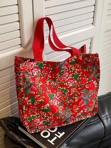 Ethnic red floral canvas tote bag with peony pattern shown on a modern studio background