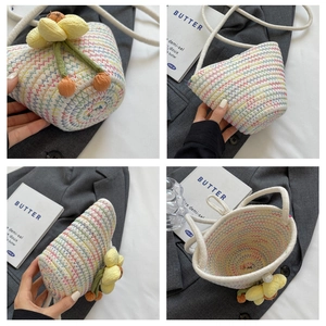 Detail of colorful zigzag woven bucket bag with 3D yellow flowers and slim strap