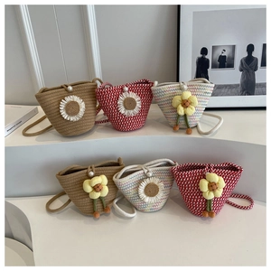 Detailed view of handmade woven mini bucket bags with floral decors and pearl buckles