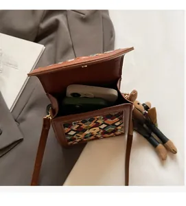 Detailed interior of vintage brown cross-body phone bag showing space for two smartphones