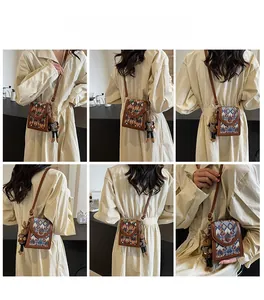 Detailed view of crossbody bags with geometric embroidery and cute bunny charms