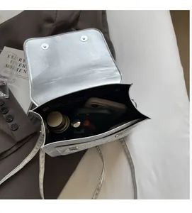 Interior view showing the spacious storage capacity of the silver bow shoulder bag