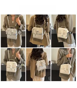 Detail of white mini bow backpack showing versatile shoulder and crossbody strap options