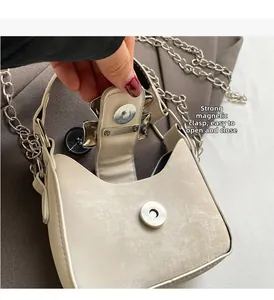 Detail showing strong magnetic closure and frosted texture on mini crossbody bag