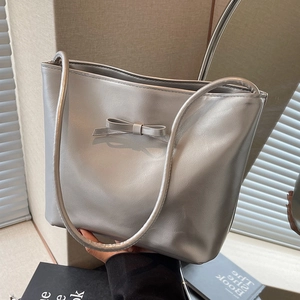 Silver tote bag with bow detail and slim shoulder strap for daily casual commuting