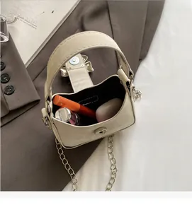 Interior view of mini bow handbag showing space for lipstick and makeup cushions
