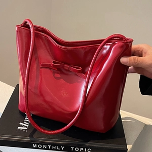 Fashionable red glossy PU tote bag with bow detail for women, perfect for daily commuting
