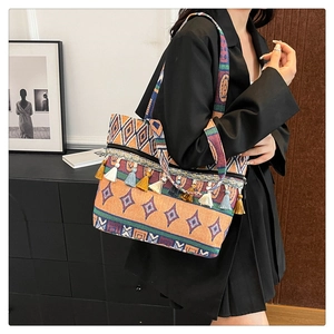 Detailed look at colorful bohemian tote bag with fringe tassels and geometric weaving