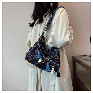Close-up of ethnic tote bag with colorful geometric patterns and stylish blue tassels