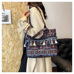 Close-up of ethnic geometric weave tote bag with colorful fringe and wide shoulder strap
