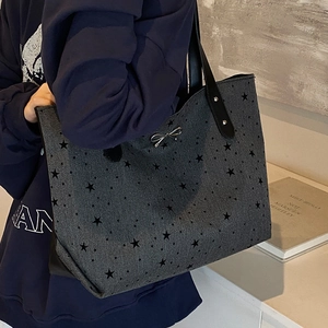 Star pattern grey denim tote bag with bow detail and black leather shoulder straps