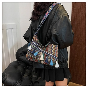 Close-up of bohemian tote bag with colorful geometric patterns and decorative tassels
