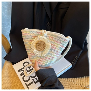 Detail of woven mini bag with colorful stitching, large daisy flower and pearl button