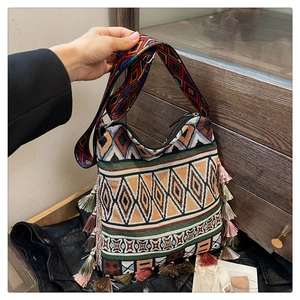 Detail of bohemian tote bag with colorful geometric patterns and decorative tassels