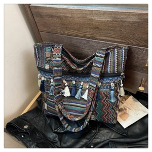 Detail of bohemian tote bag with colorful geometric weave and multi-color tassels