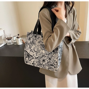 French vintage style canvas tote bag featuring black floral prints and double black straps