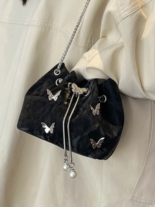 Fashionable black velvet bucket bag with silver butterfly charms and pearl drawstring chain