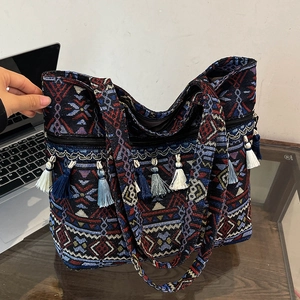 Ethnic style woven tote bag with geometric patterns and colorful tassel decorations