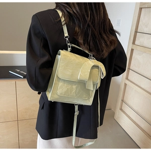Light green pleated mini backpack with a large bow detail shown on a female model