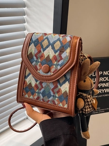Vintage geometric woven crossbody phone bag with brown leather trim and cute rabbit charm