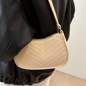 Chic off-white chevron quilted underarm bag with gold hardware and slim strap