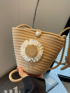 Handmade woven crossbody bucket bag with daisy flower and pearl clasp detail