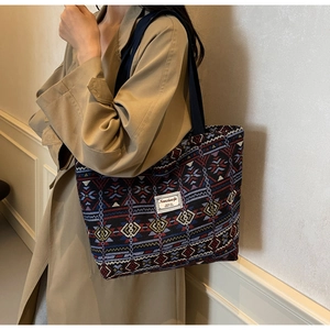Detailed shot of retro ethnic printed canvas bucket bag with vintage geometric patterns