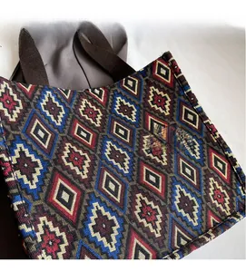 Close-up of bohemian tote bag featuring colorful geometric jacquard fabric and canvas handles