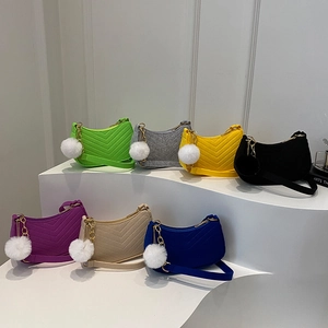 Minimalist felt half-moon shoulder bags in multiple colors with plush pom pom charms