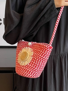 Handmade red and white woven crossbody bag with a large sunflower and pearl button closure