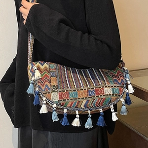 Bohemian hand-woven crossbody bag with vibrant geometric patterns and fringed tassels
