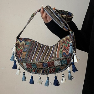Bohemian crescent shoulder bag with colorful geometric woven patterns and long tassels
