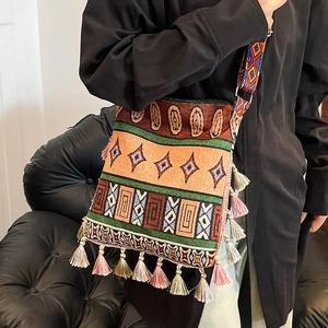 Bohemian woven tote bag with colorful tassels and geometric patterns on wide strap