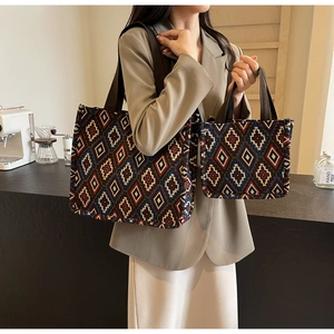 Detail of vintage geometric woven tote bag and mini handbag with thick brown straps
