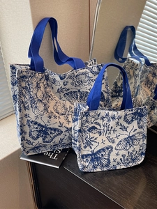 Blue and white floral knit tote bag set with butterfly patterns and ribbon handles