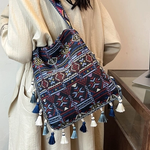Bohemian oversized woven tote bag with fringe details and ethnic patterns for women