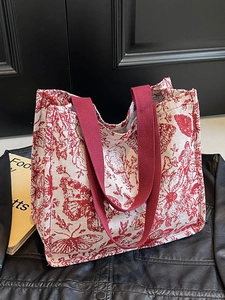 Knitted tote bag with red and white butterfly floral patterns and wide ribbon handles