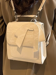 Chic off-white bow backpack in pleated faux leather for women stylish minimalist design