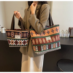 Detail of retro geometric woven pattern on large canvas bucket bag and matching small handbag