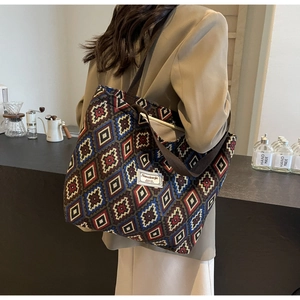 Close-up of retro geometric pattern large canvas bucket bag with detailed brand patch