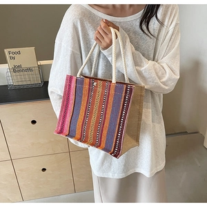 Detail of colorful striped woven tote bag with cotton rope handles for a bohemian style
