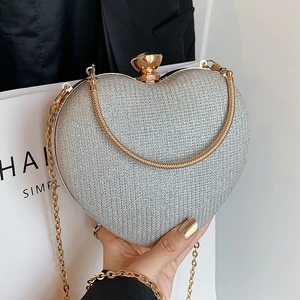 Silver heart-shaped glitter evening clutch bag with gold chain and metal clasp