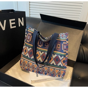 Detail of bohemian jacquard woven tote bag with colorful geometric patterns and cotton handles