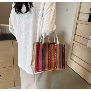 Detail of bohemian striped tote bag showing durable woven texture and rope handles