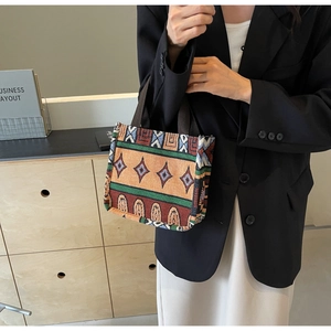 Detail showing ethnic jacquard woven fabric and colorful geometric patterns on the tote bag