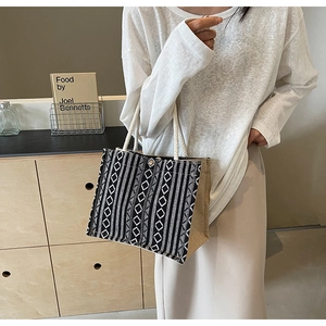Detail of ethnic knit tote bag featuring geometric patterns and soft cotton rope handles
