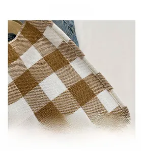Close-up of the brown gingham check texture and stitching on a large tote bag